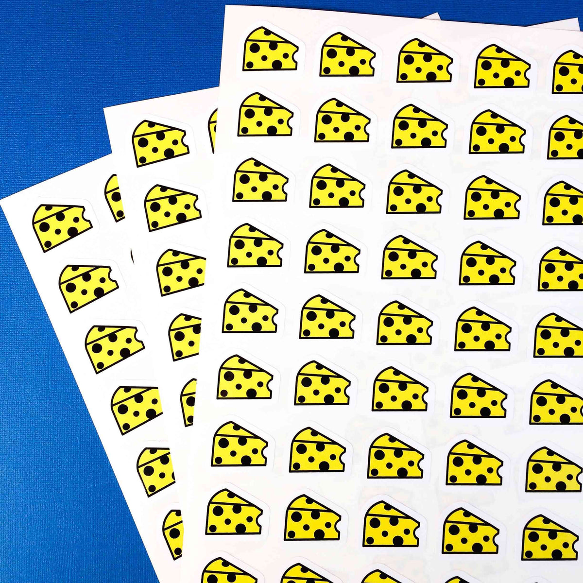 Custom shape cartoon cheese stickers on a sheet.